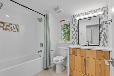 an aerial view of a house with yard