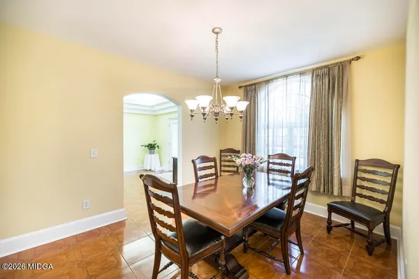 a large kitchen with kitchen island a stove a sink dishwasher and a refrigerator with wooden floor