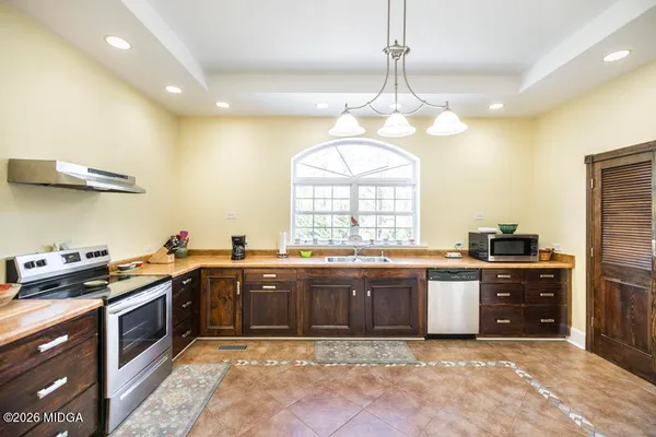 a kitchen with a stove and cabinets