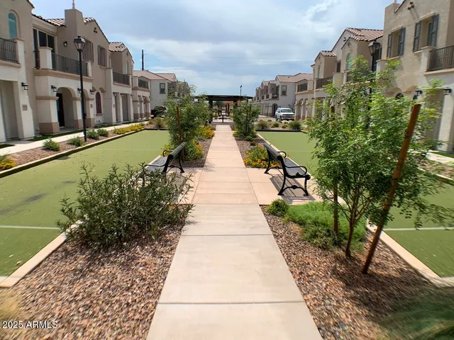 a view of a brick building next to a yard