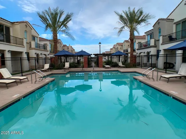a swimming pool with outdoor seating and yard