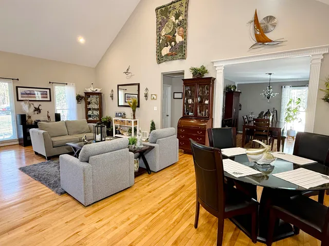 a kitchen with stainless steel appliances granite countertop a table chairs and a refrigerator