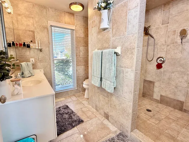 a bathroom with a sink a mirror and shower