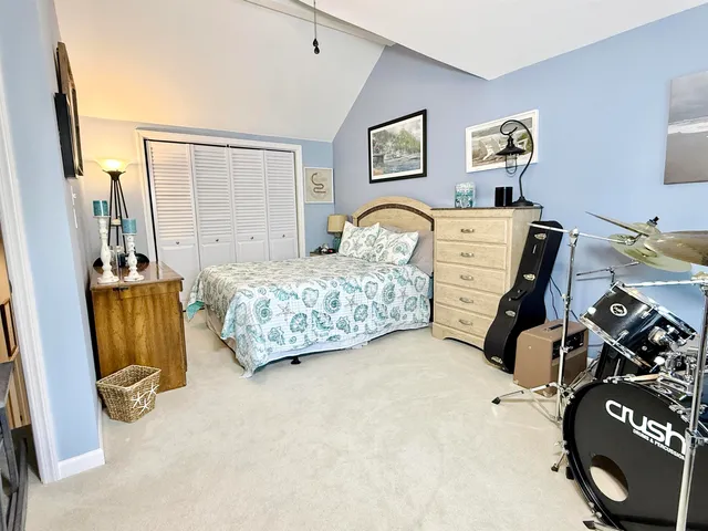 a bed room with a bed and a chair