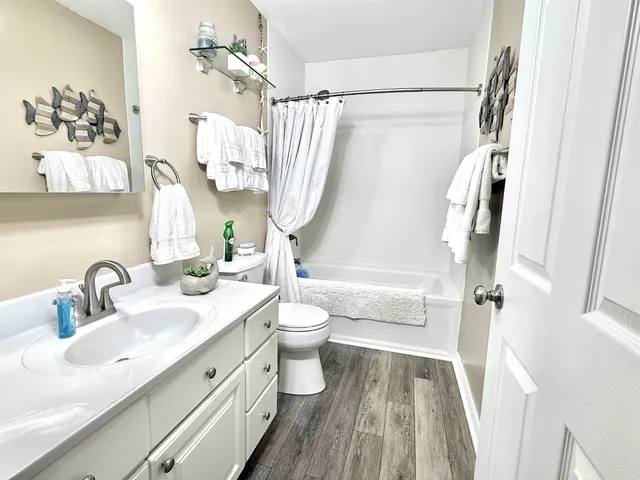 a bed sitting in a bedroom next to a book shelf