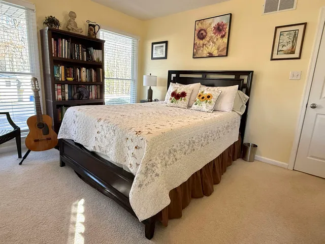 a spacious bedroom with a bed and furniture