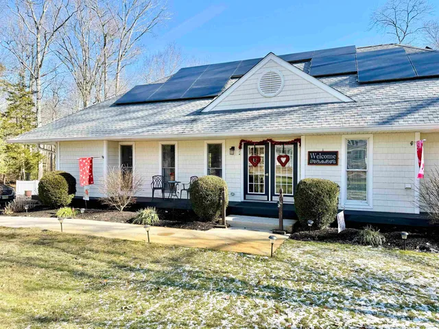 a front view of house with yard outdoor seating and barbeque oven