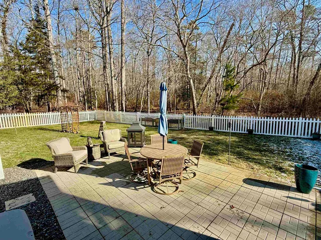 a living room with fireplace furniture and a large window