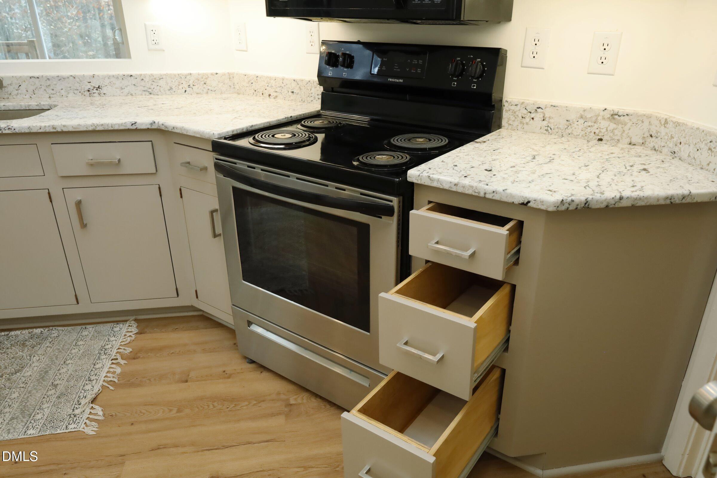 237 Glen Eden Road Durham, NC 27713 - Photo 16 of 37 a kitchen with a stove and a microwave