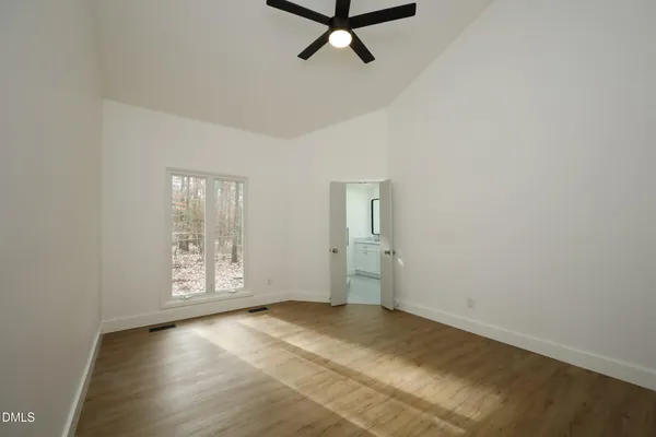 an empty room with windows and closet