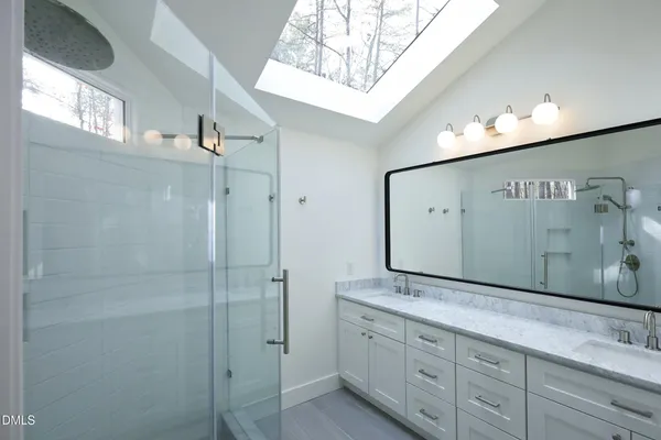 a bathroom with a granite countertop sink mirror and double