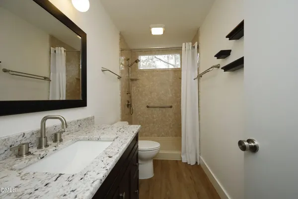 a bathroom with a shower and a toilet