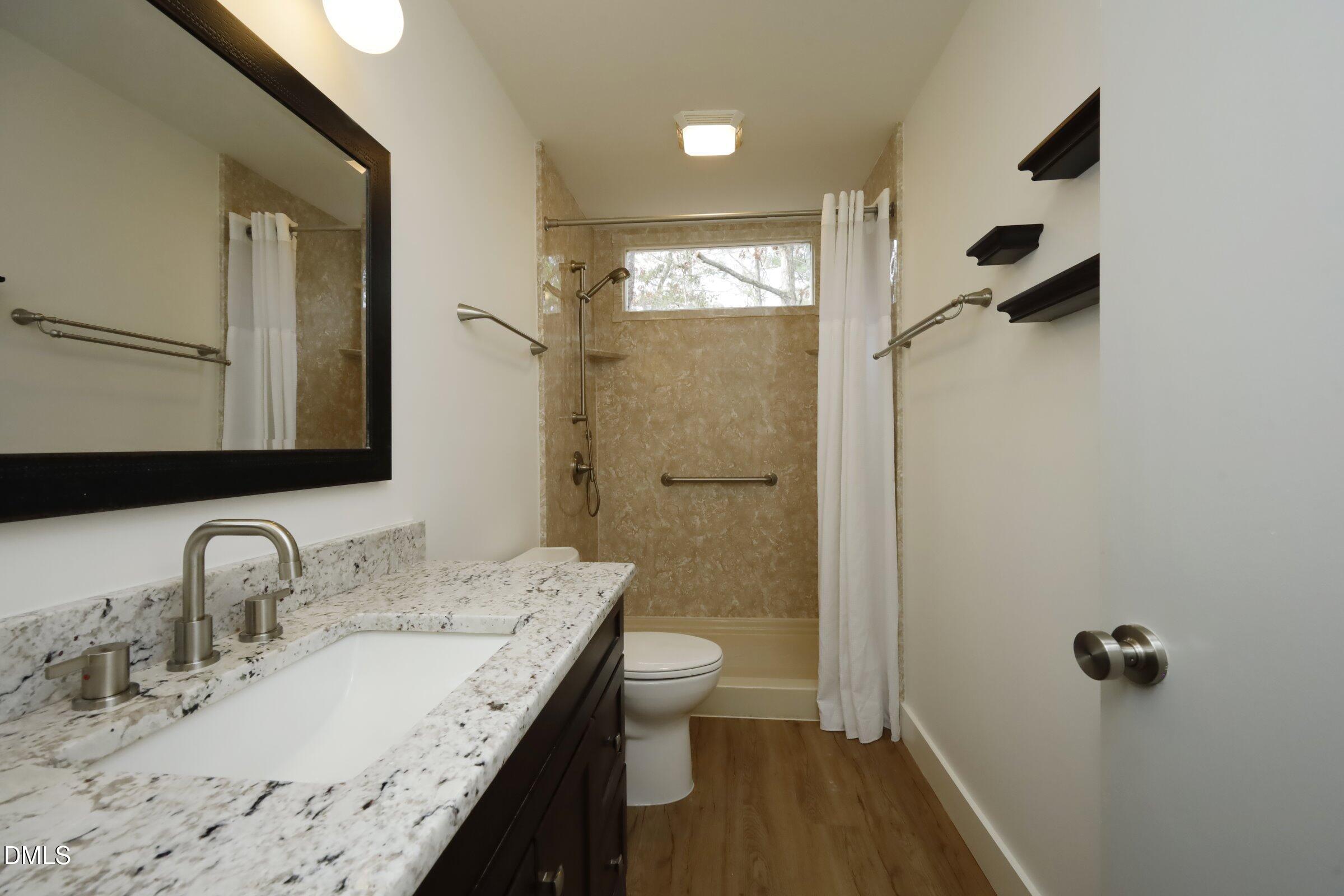 237 Glen Eden Road Durham, NC 27713 - Photo 26 of 37 a bathroom with a granite countertop sink toilet and shower