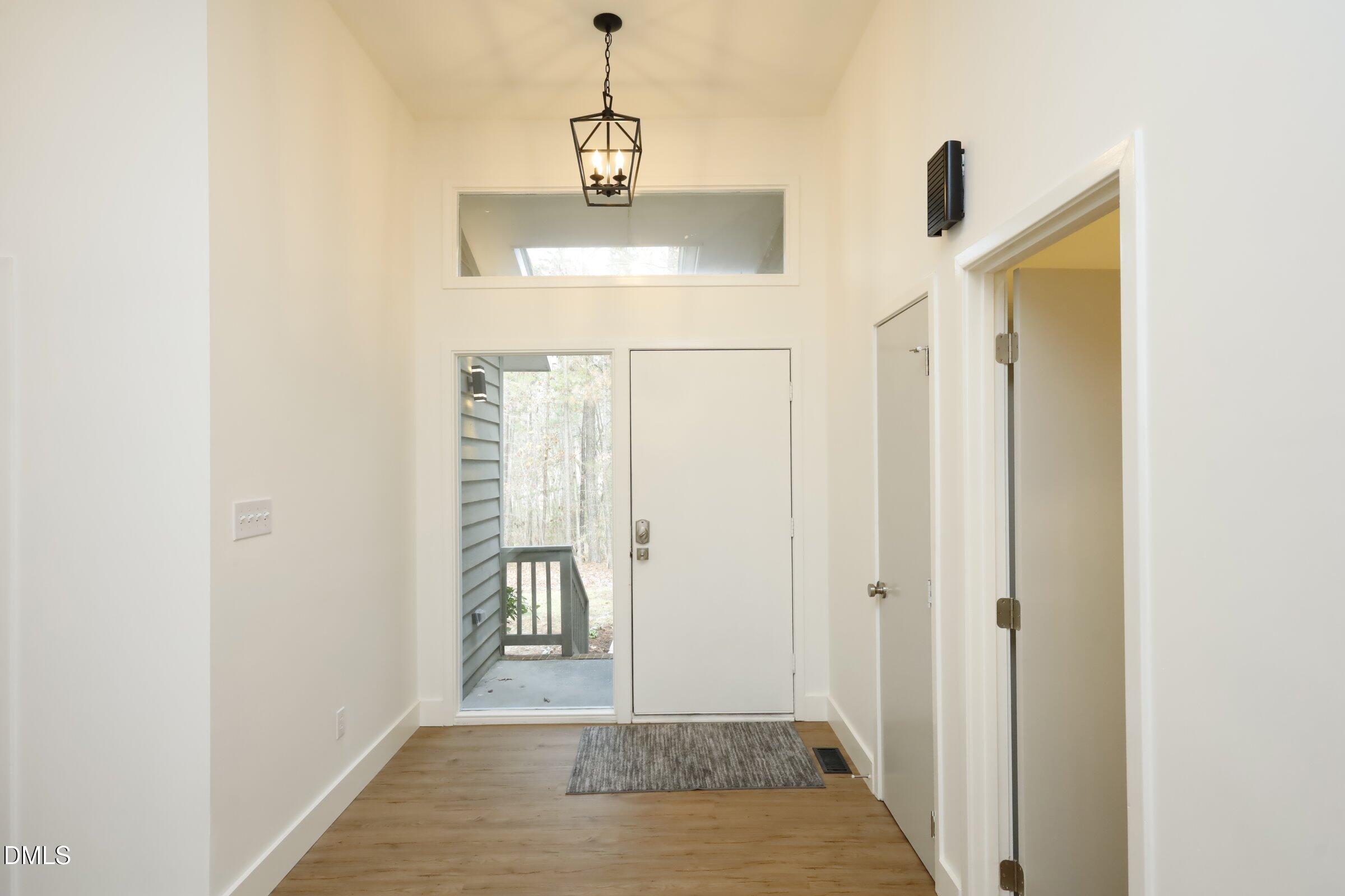 237 Glen Eden Road Durham, NC 27713 - Photo 4 of 37 a view of a hallway with wooden floor and a bathroom