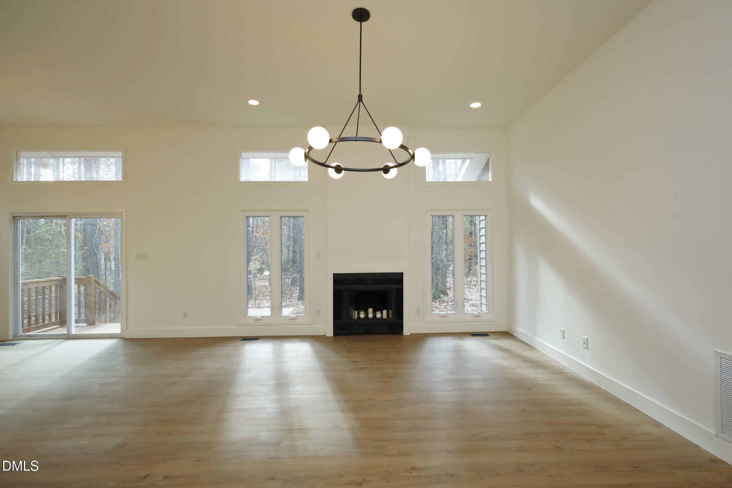 237 Glen Eden Road Durham, NC 27713 - Photo 6 of 37 a view of a livingroom with a fireplace wooden floor and a window