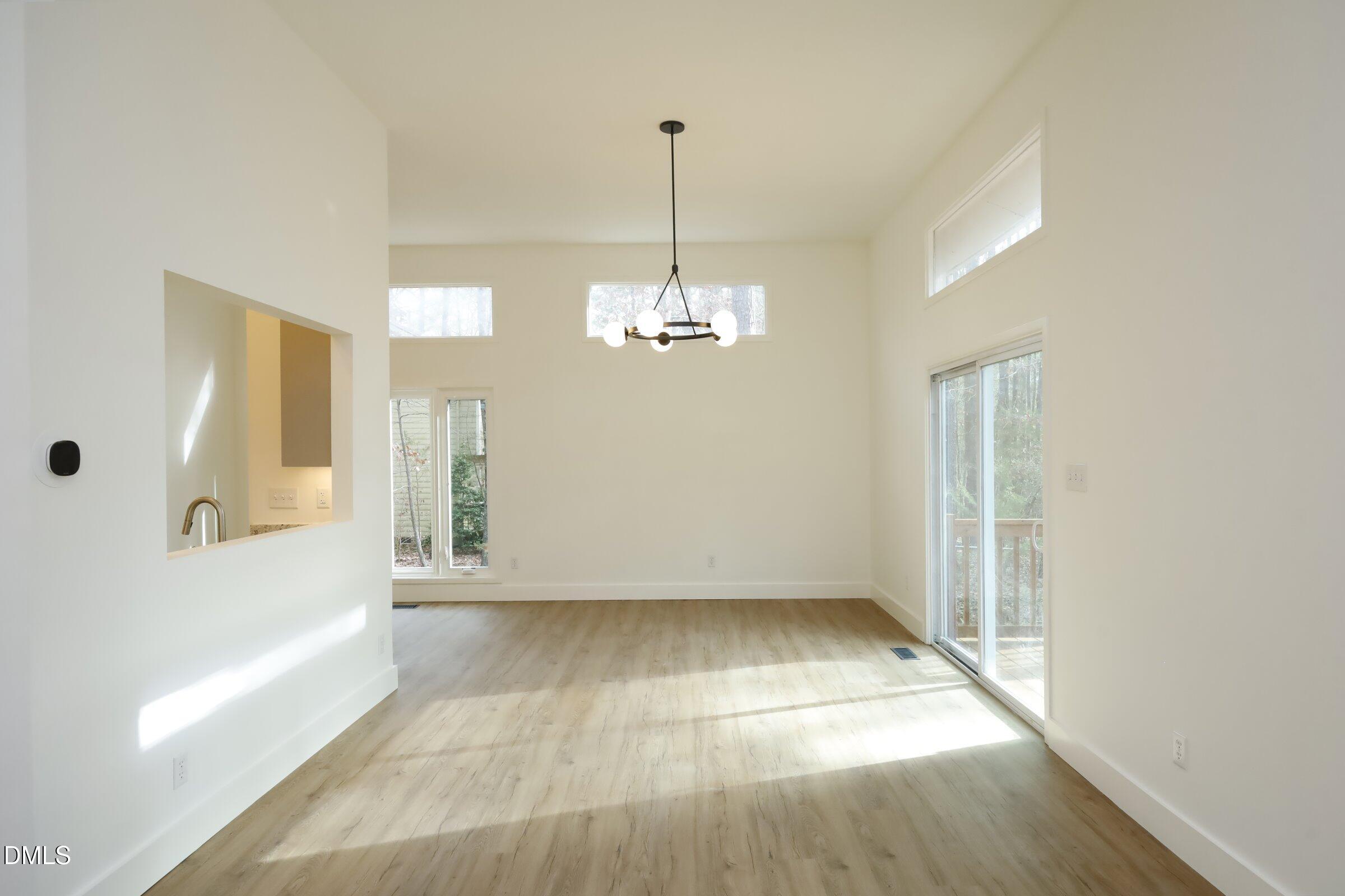 237 Glen Eden Road Durham, NC 27713 - Photo 9 of 37 a view of empty room with wooden floor and fan