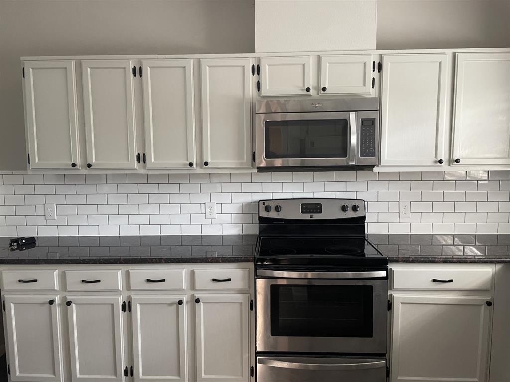 5310 Keller Springs Road, Unit 132 Dallas, TX 75248 - Photo 7 of 11 a kitchen with cabinets and stainless steel appliances