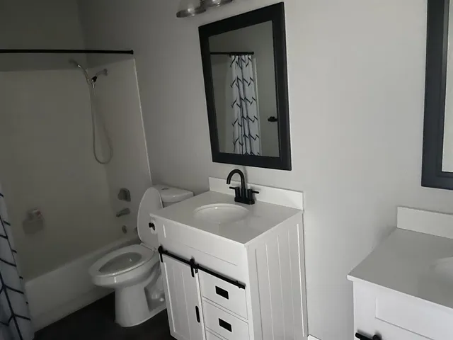 a bathroom with a toilet sink and mirror