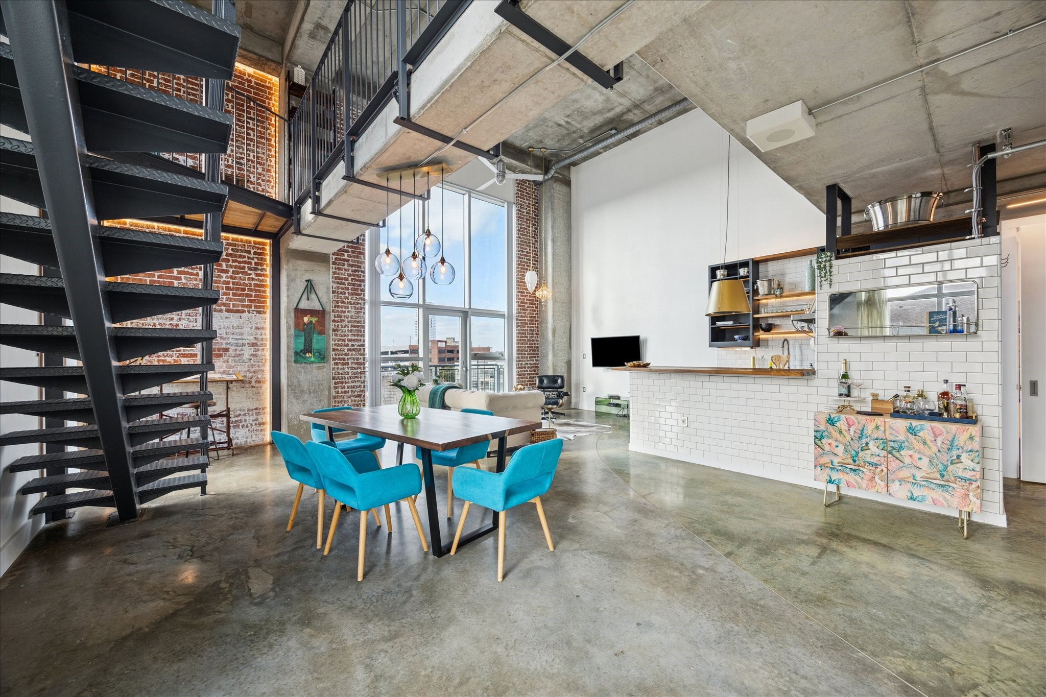 2000 Bagby Street, Unit 5400 Houston, TX 77002 - Photo 11 of 47 Spacious dining room highlighted by a freshly painted iron staircase, adding a clean, modern touch and striking architectural detail to the space.
