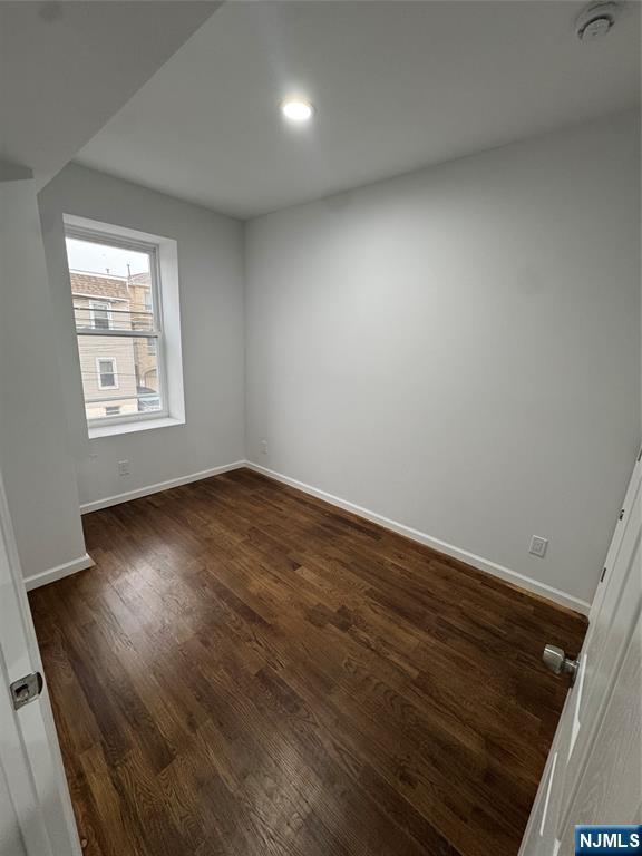 196 Malvern Street, Unit 1 Newark, NJ 07105 - Photo 13 of 16 an empty room with wooden floor and windows