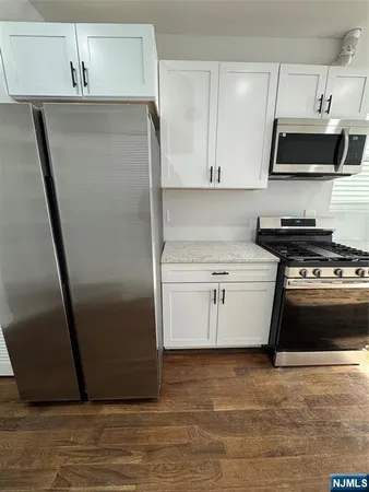 a kitchen with stainless steel appliances a refrigerator stove and sink