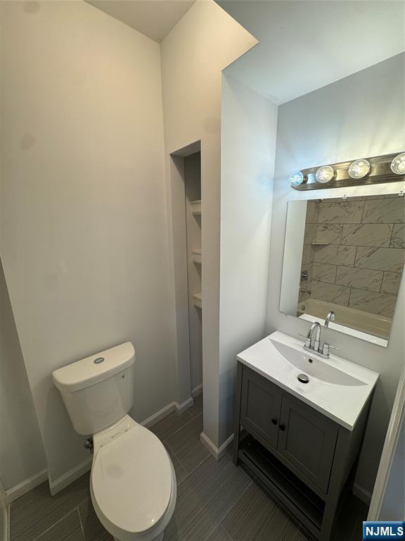 196 Malvern Street, Unit 1 Newark, NJ 07105 - Photo 9 of 16 a bathroom with a toilet sink and mirror