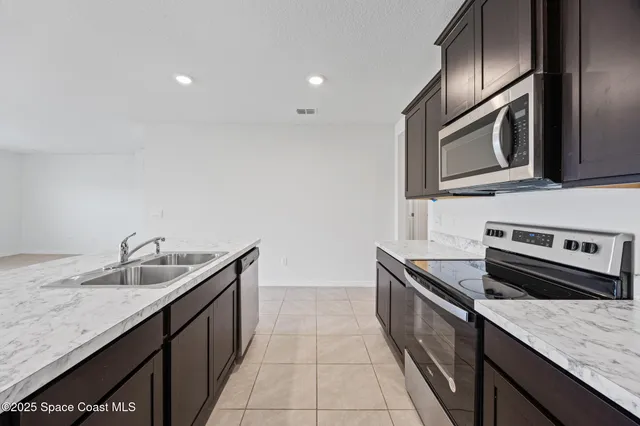 a kitchen with granite countertop stainless steel appliances and sink