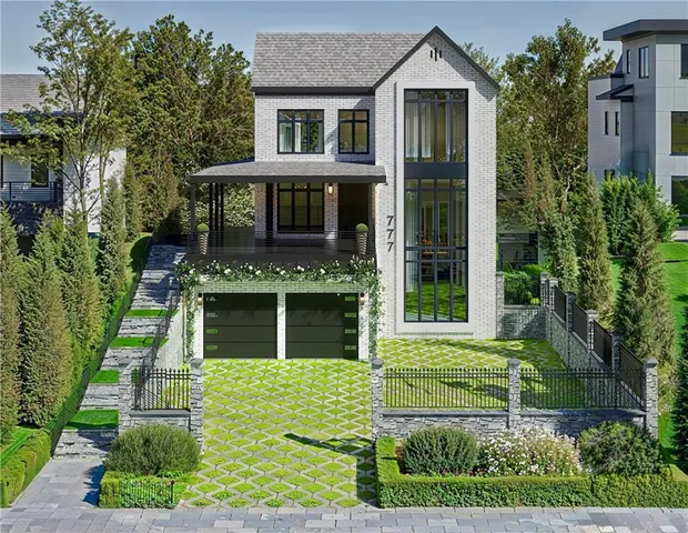 a front view of a house with a garden