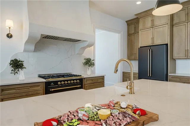 a kitchen with sink a stove and refrigerator