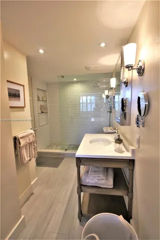 a view of a hallway with wooden floor and glass door