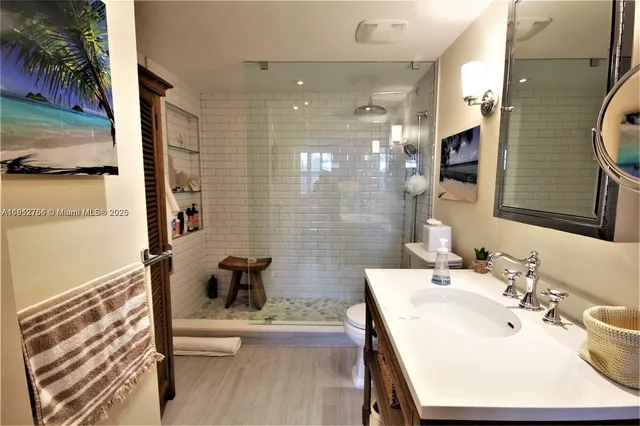 a bedroom with two beds and a chandelier