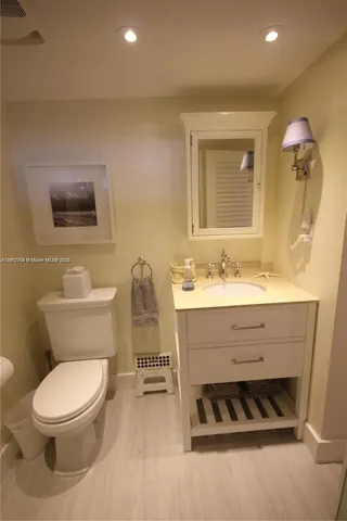 a bathroom with a sink vanity and a mirror