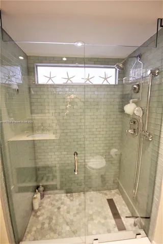 a bedroom with two beds and a large window