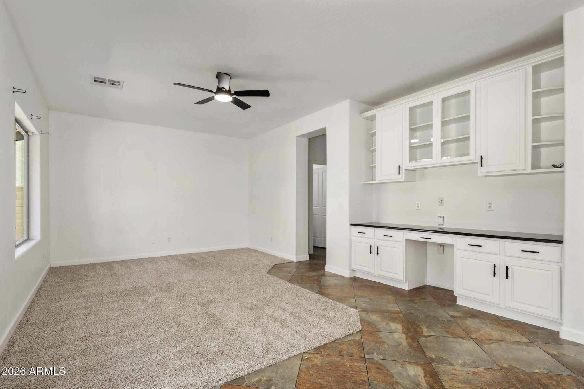 5121 West Beverly Road Laveen, AZ 85339 - Photo 13 of 32 an empty room with kitchen appliances and windows