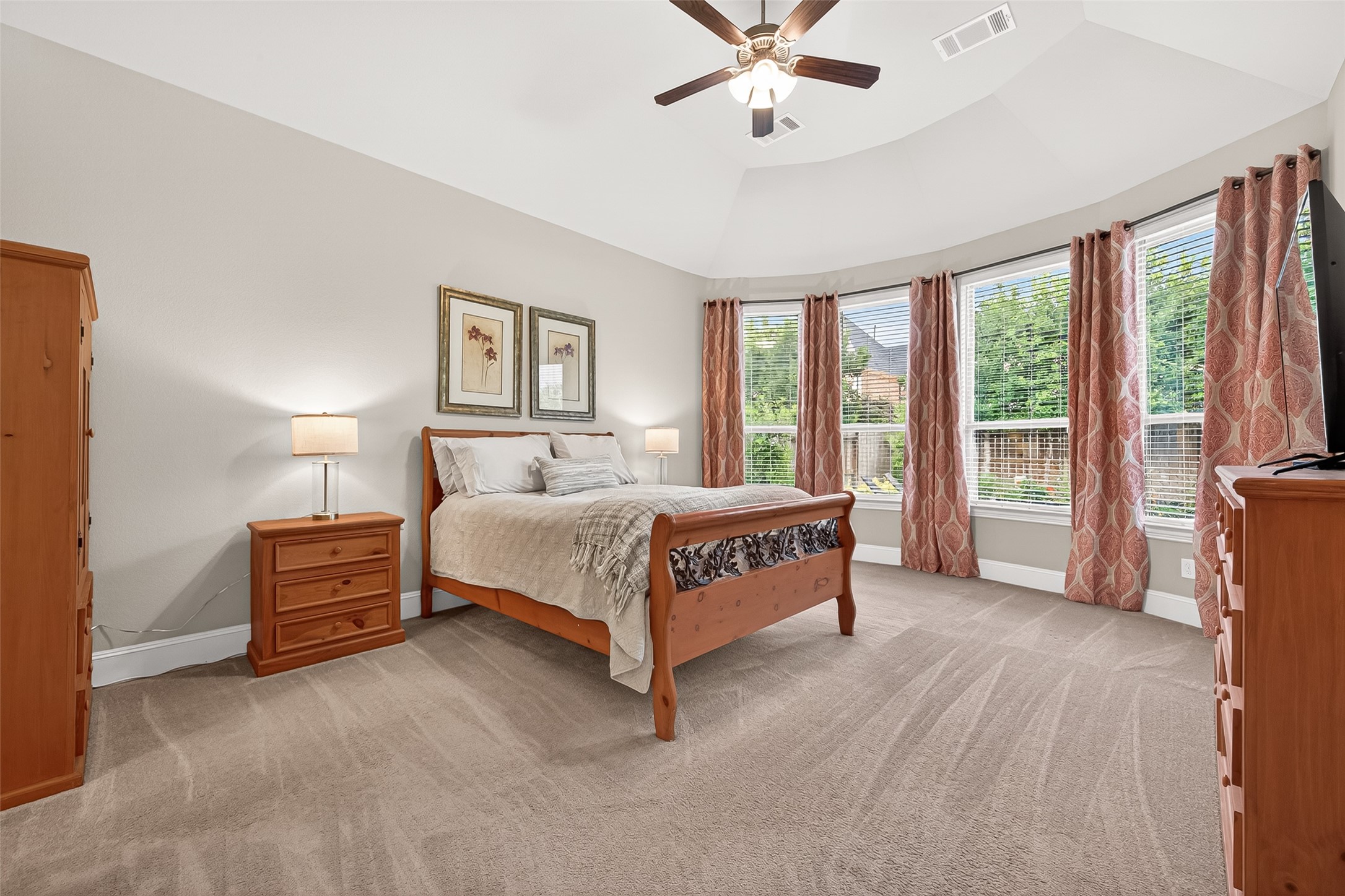 2803 Mayfield Ridge Lane Katy, TX 77494 - Photo 24 of 40 Very large Primary Suite with vaulted ceiling and half bay window overlooking the backyard retreat surrounded by mature trees.