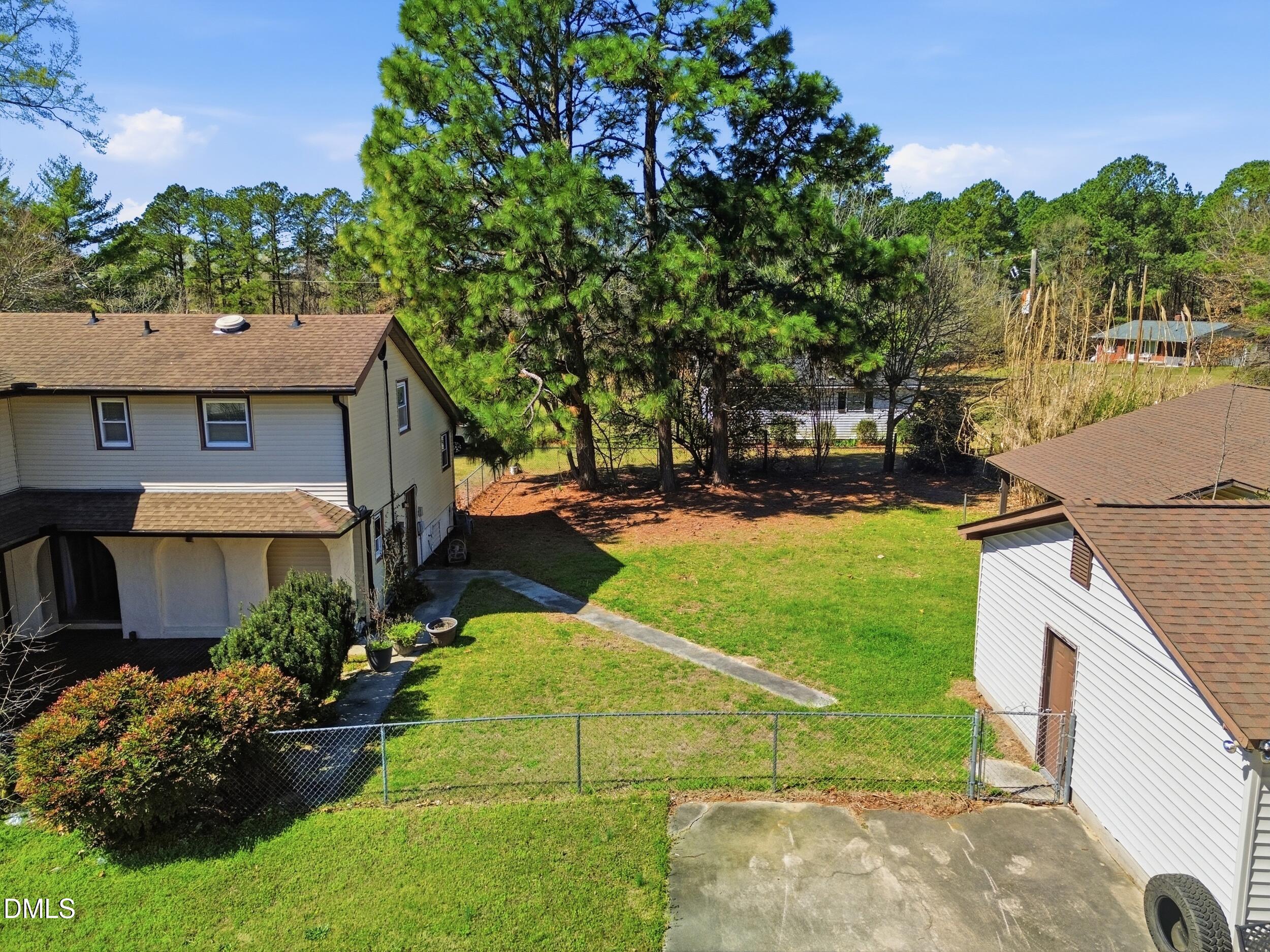 19405 Highway 210 Angier, NC 27501 - Photo 14 of 49 a view of a backyard with plants and a patio