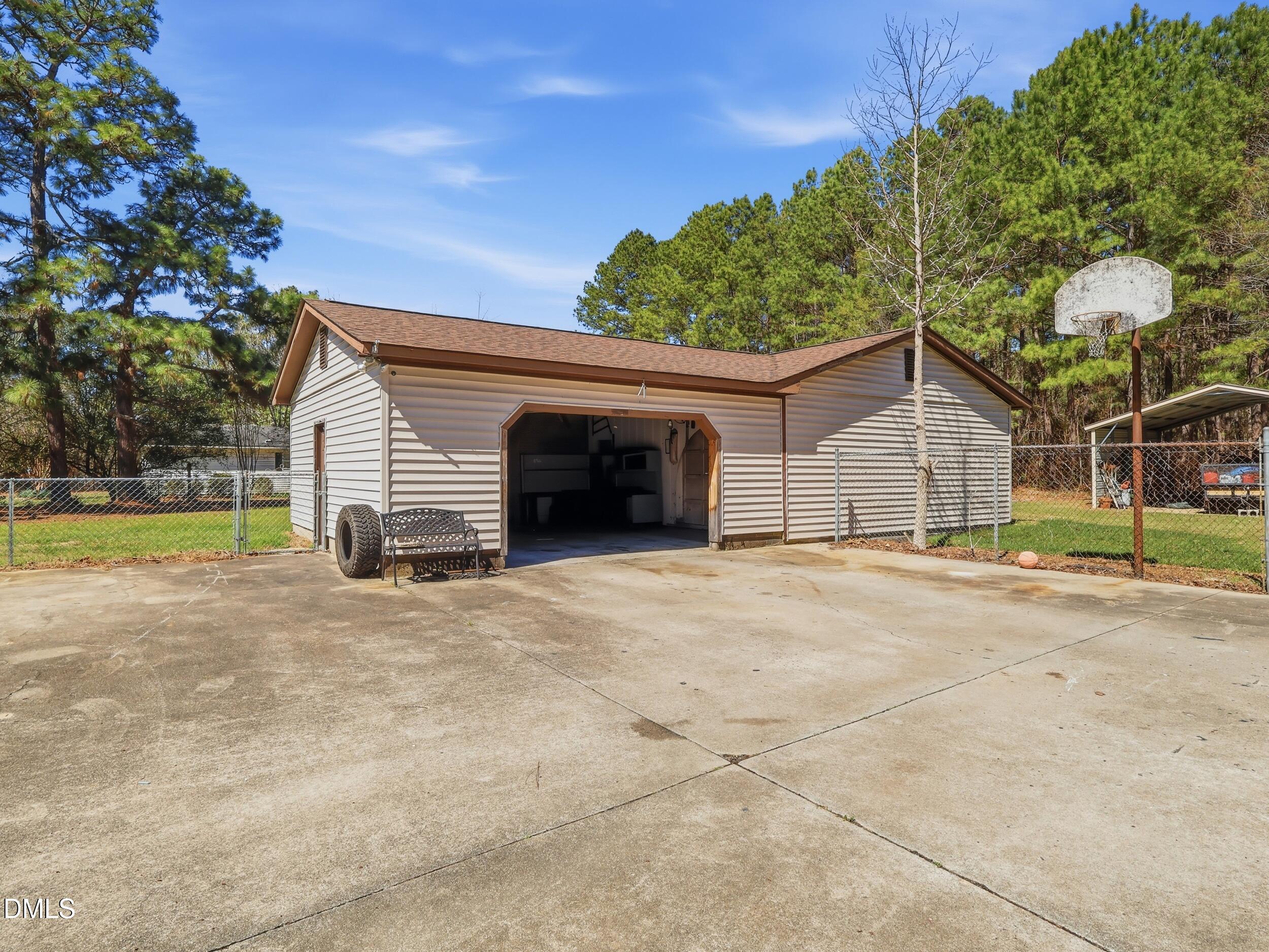 19405 Highway 210 Angier, NC 27501 - Photo 46 of 49 a view of a house with a yard and garage