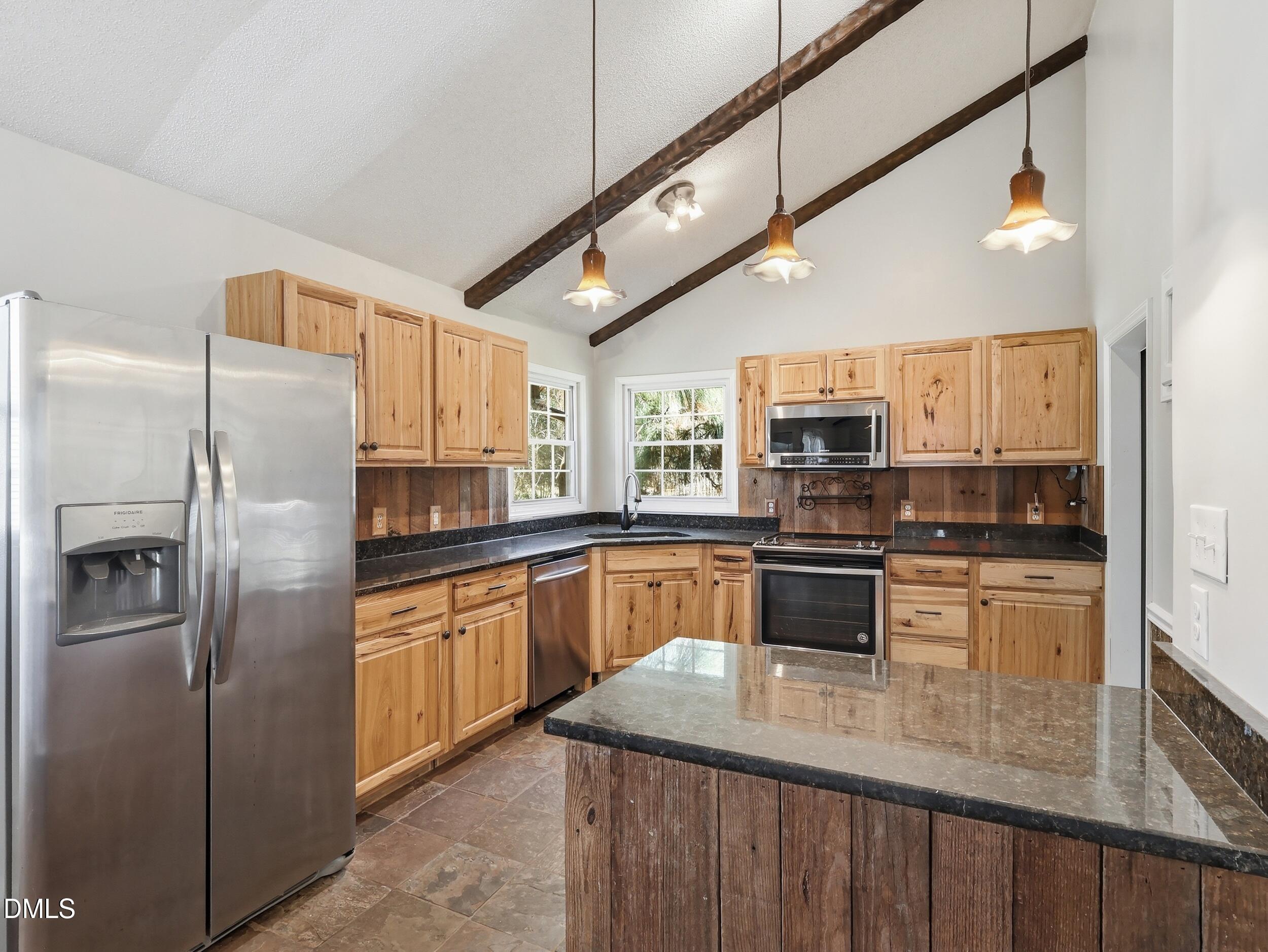 19405 Highway 210 Angier, NC 27501 - Photo 5 of 49 a kitchen with stainless steel appliances granite countertop a refrigerator a stove and a sink with wooden floor