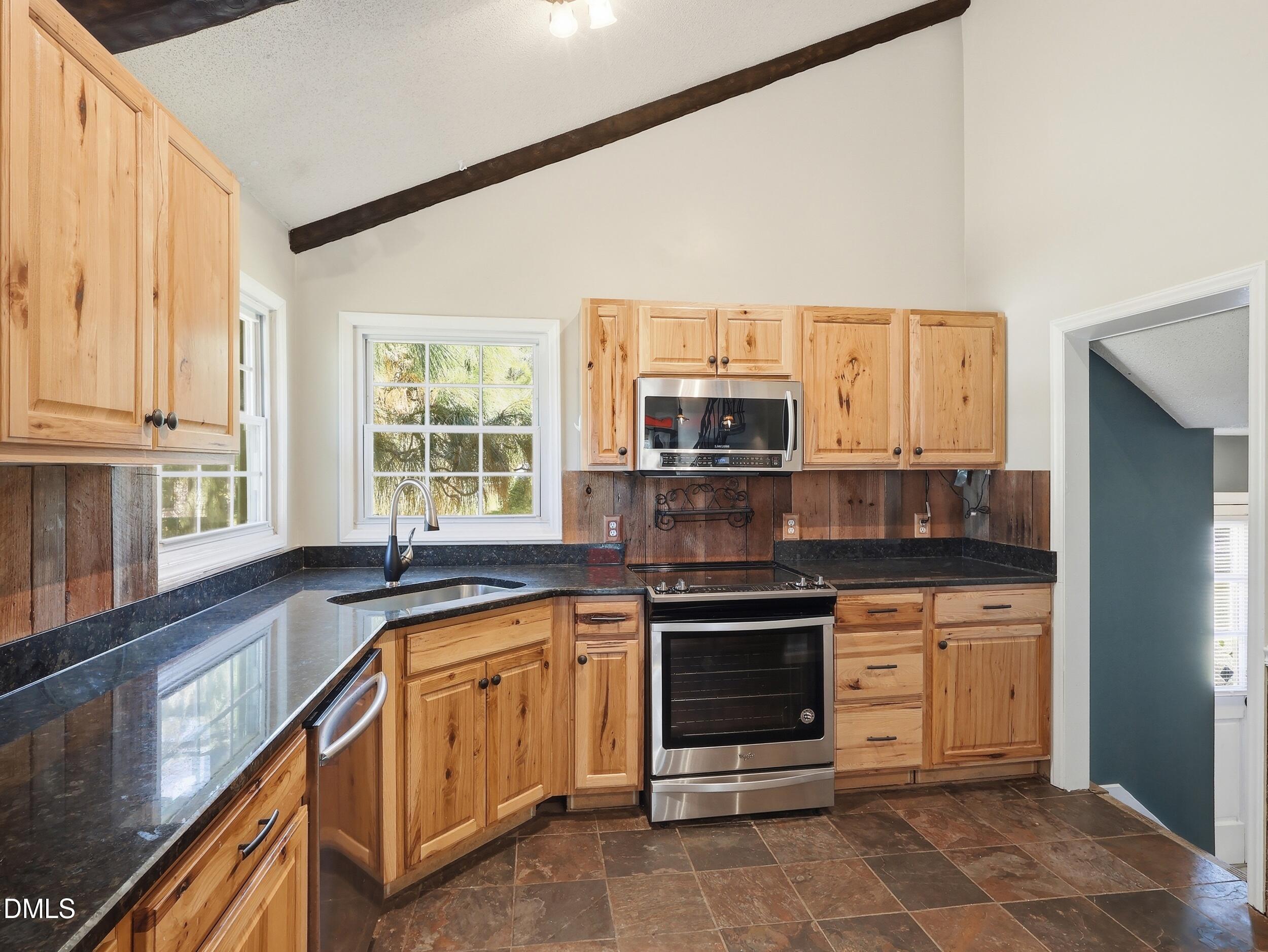 19405 Highway 210 Angier, NC 27501 - Photo 7 of 49 a kitchen with stainless steel appliances granite countertop a stove and a sink