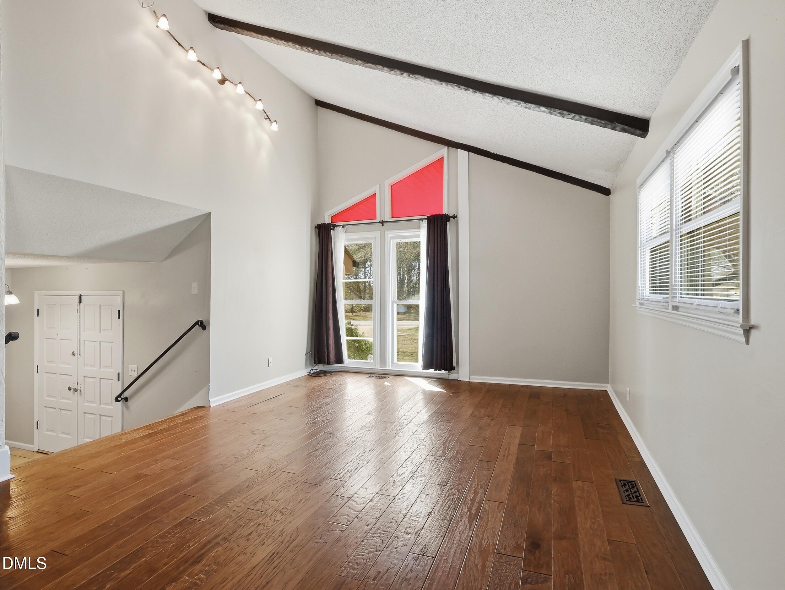 19405 Highway 210 Angier, NC 27501 - Photo 9 of 49 a view of an empty room with wooden floor and a window