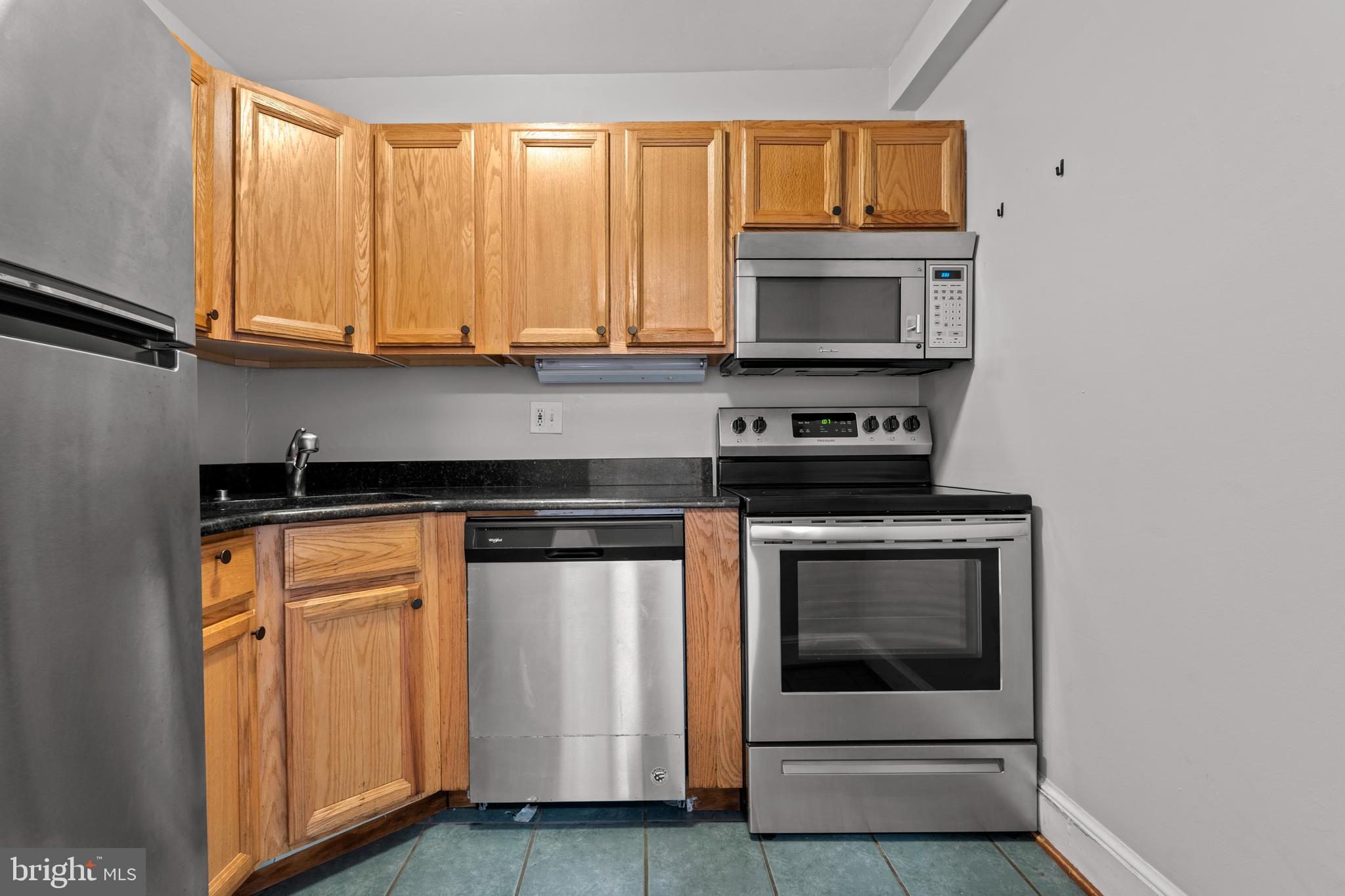 1815 East Capitol Street Southeast, Unit 1 Washington, DC 20003 - Photo 11 of 19 a kitchen with stainless steel appliances granite countertop a stove and a microwave