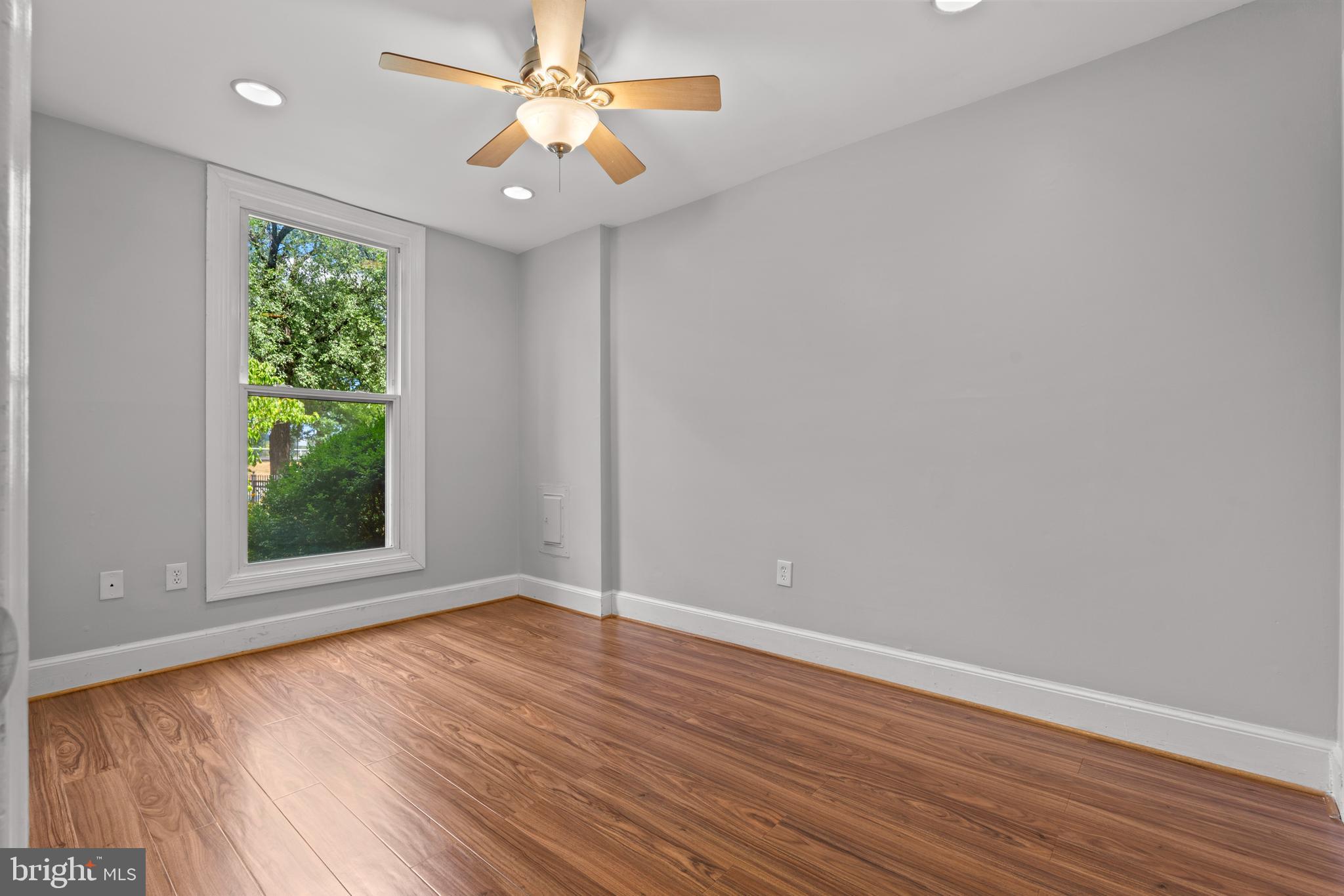 1815 East Capitol Street Southeast, Unit 1 Washington, DC 20003 - Photo 6 of 19 an empty room with wooden floor fan and windows