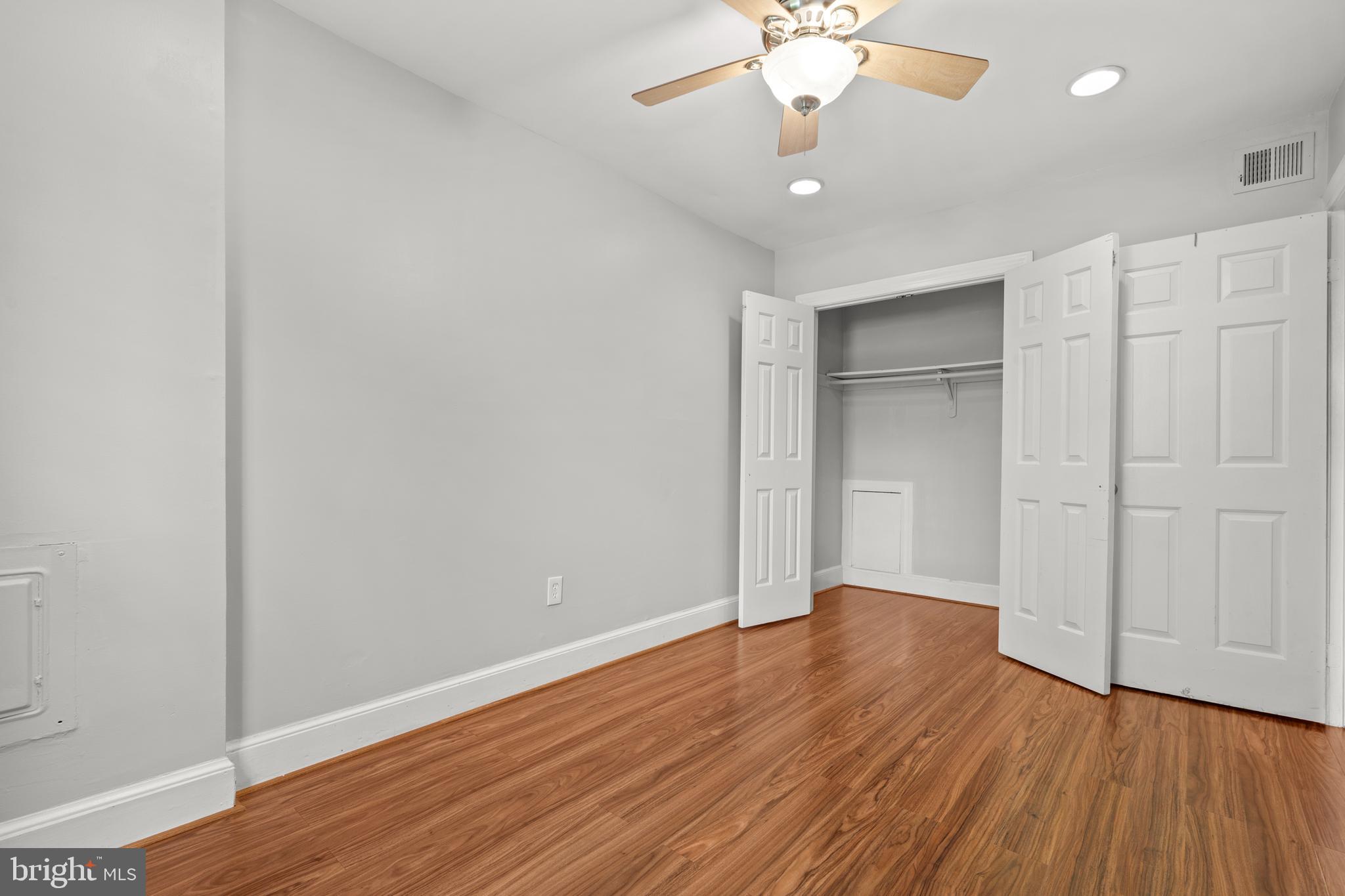 1815 East Capitol Street Southeast, Unit 1 Washington, DC 20003 - Photo 7 of 19 an empty room with wooden floor and windows