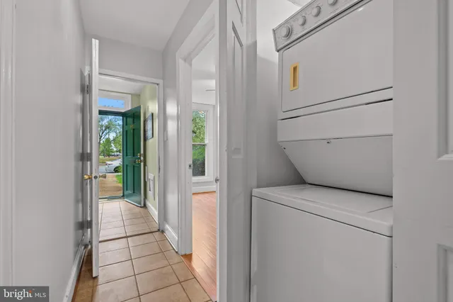 a view of a livingroom with wooden floor a fireplace and windows