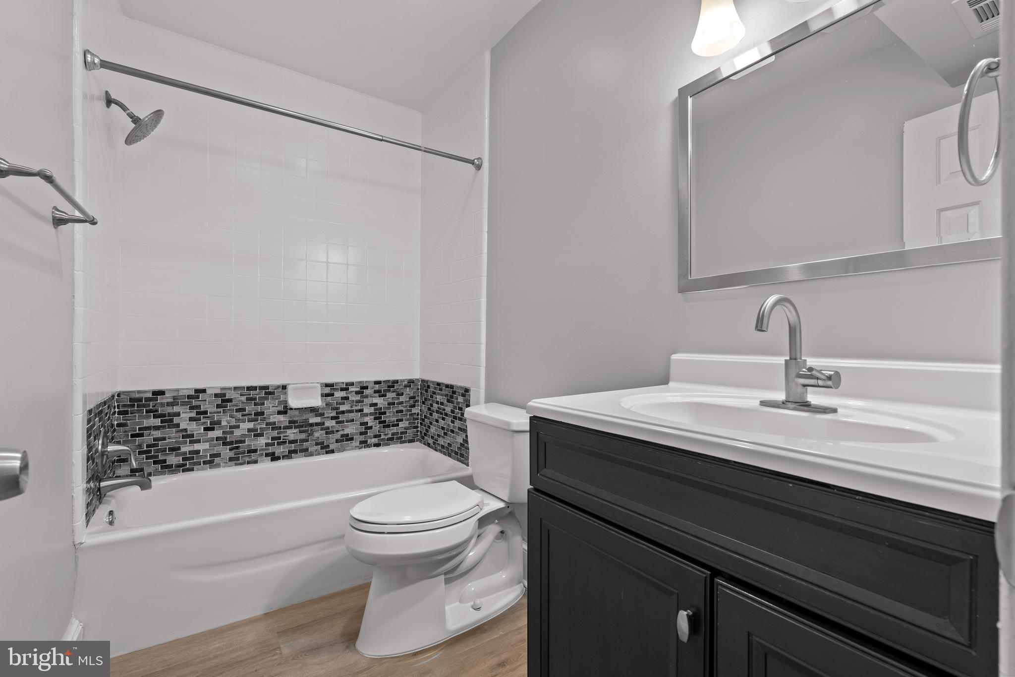 1815 East Capitol Street Southeast, Unit 1 Washington, DC 20003 - Photo 9 of 19 a bathroom with a sink a toilet a shower and a mirror