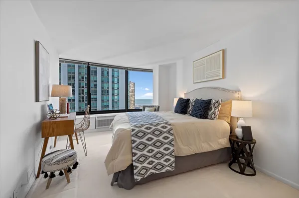 a bedroom with a bed and a lamp on table