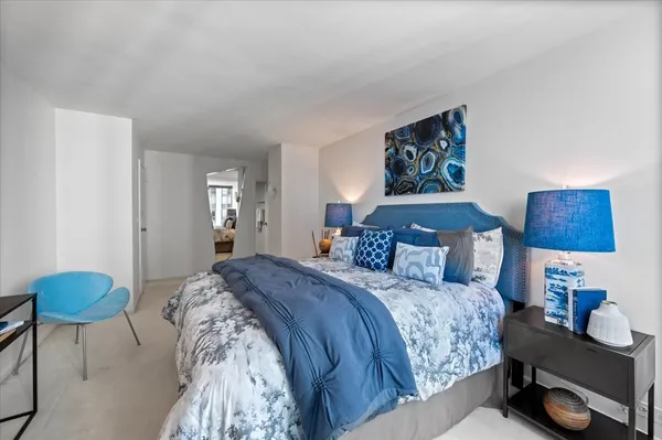 a bedroom with a bed a lamp and a window