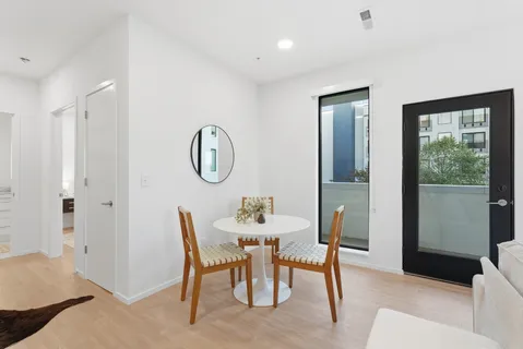 a dining room with furniture and a mirror