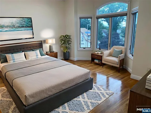 a bedroom with a large bed and a large window