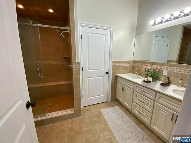 a bathroom with a shower sink and mirror